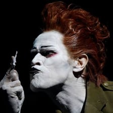 An actor making an exaggerated theatrical gesture