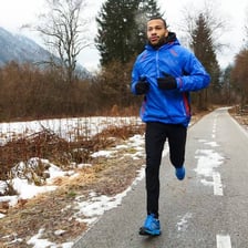 A person running outdoors in cold weather