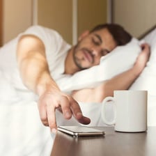 A person waking up in bed
