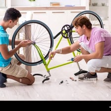 A person repairing a damaged bicycle