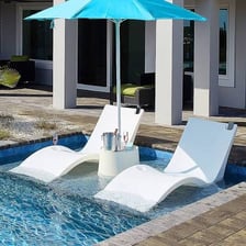 A reclining lounger beside a swimming pool