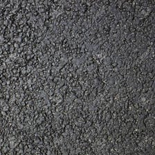 A newly surfaced road covered in dark tar