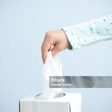 A hand pulling an object out of a container