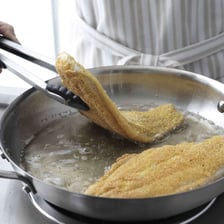 Fish being fried in a pan.