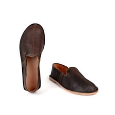 A single leather shoe viewed from the side