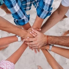 People joining hands to form a united group.