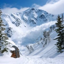 A mass of snow cascading down a mountain slope