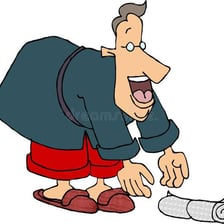 A person bending forward to pick up an object from the ground.