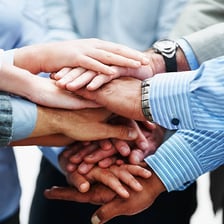 Two people clasping hands as a symbol of loyalty.