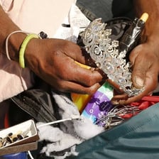 A person shown with belongings that they possess.