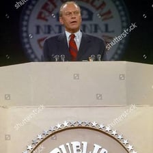A dignified political leader delivering a formal speech