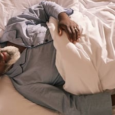 A person remaining in bed during a late morning.