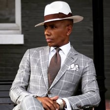 A well-dressed, sophisticated man in formal clothing