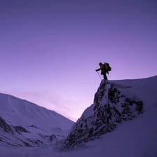 A hiker undertaking a demanding mountain climb