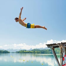 A diver entering a swimming pool