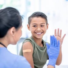 A healthcare worker giving a patient a vaccination