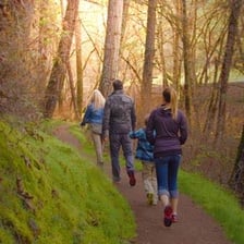 A hiker walking behind a group on a trail