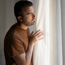 A person gazing into the distance with a wistful expression