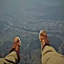 A person confronting a fear of heights at a high viewpoint.