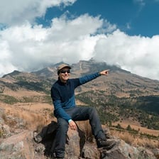 A person pointing toward a place in the distance