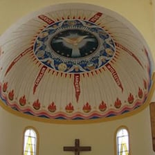 A church interior with an apse behind the altar.
