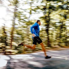 A runner moving rapidly with motion blur