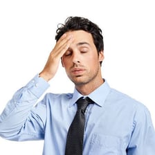 A person exhaling with a sad or weary expression.