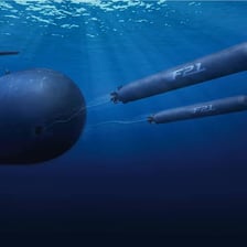 A cylindrical naval torpedo displayed as an underwater weapon