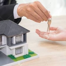 A person holding keys to a property