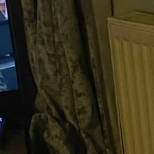 An object concealed behind a curtain