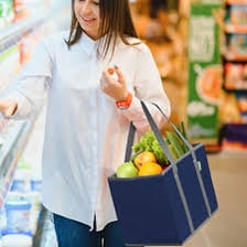 A reusable shopping bag being used to carry groceries