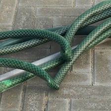 A garden hose bent into a sharp kink