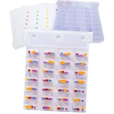 A medicine pill beside its blister pack.