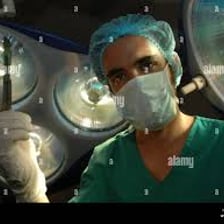 A surgeon holding a scalpel in an operating theatre