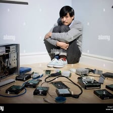 A person working at a computer with technology around them