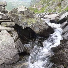 A stream beginning at its source in the mountains.