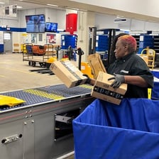 A worker providing equipment to a customer.