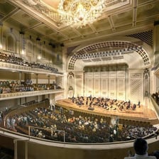 The interior of an auditorium with a concert stage and audience seating