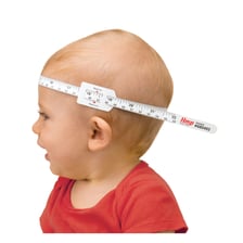 A tape measure being used to measure around an object