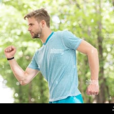 A person running outdoors, illustrating physical energy and drive.