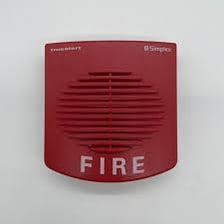 A red fire alarm mounted on a wall