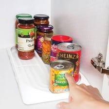 A metal food tin on a kitchen shelf.