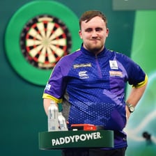 Luke Littler competing in a professional darts match.