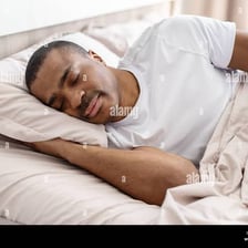 A person snuggling comfortably under a blanket