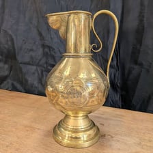 An antique large jug or ewer with a handle and spout