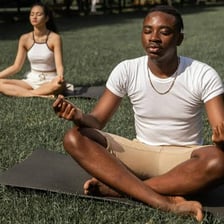 A person holding a yoga pose in meditation.