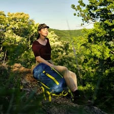A person taking a quiet rest outdoors.