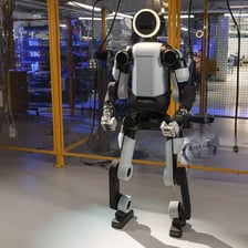 A humanoid robot standing in a laboratory or workshop.