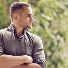A person with a serious, thoughtful expression