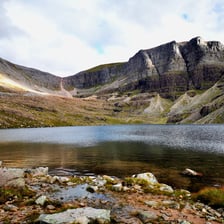 A small mountain lake surrounded by rocky upland scenery.